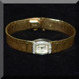J19. 14K Gold and diamond watch.